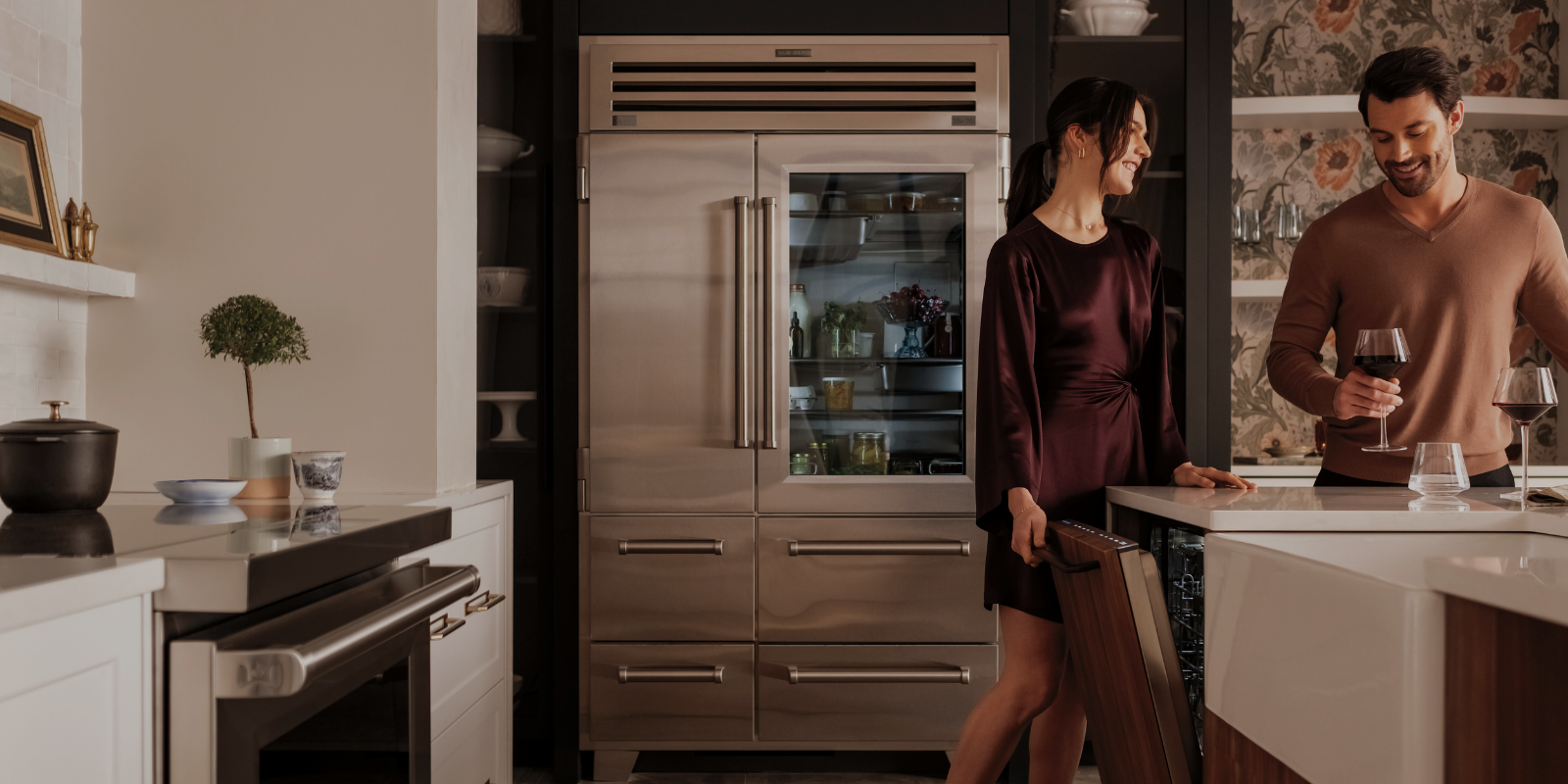 Happy couple drinking wine in a kitchen