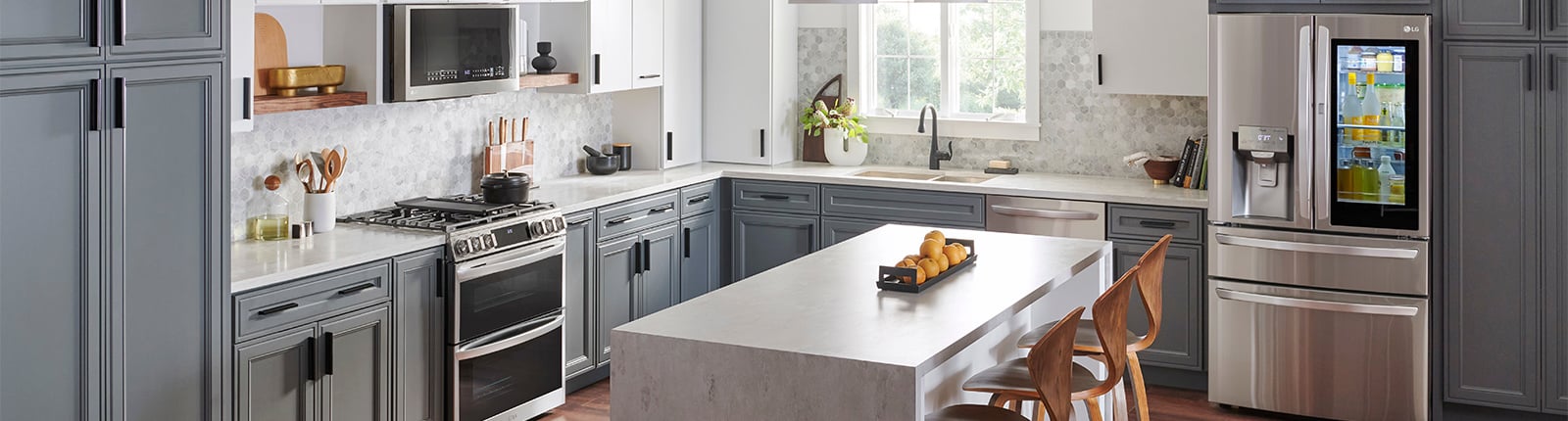 A kitchen with an island surrounded by LG appliances