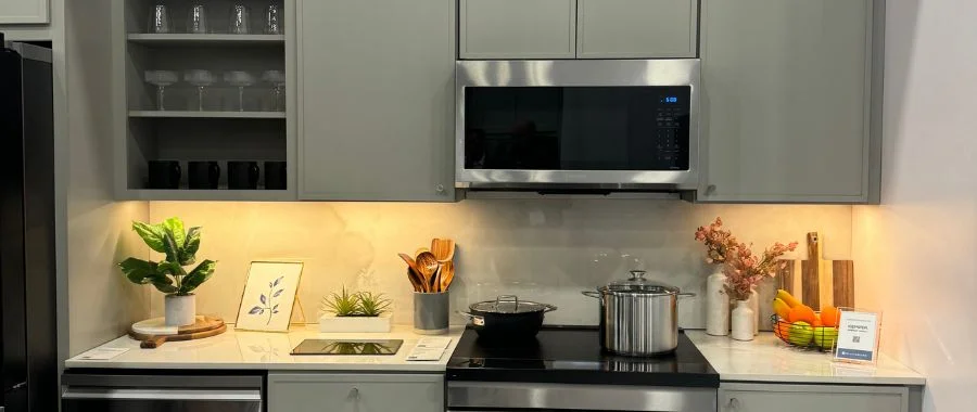 The Samsung Bespoke AI sage green kitchen display with microwave, range, dishwasher and cabinetry at KBIS 2025