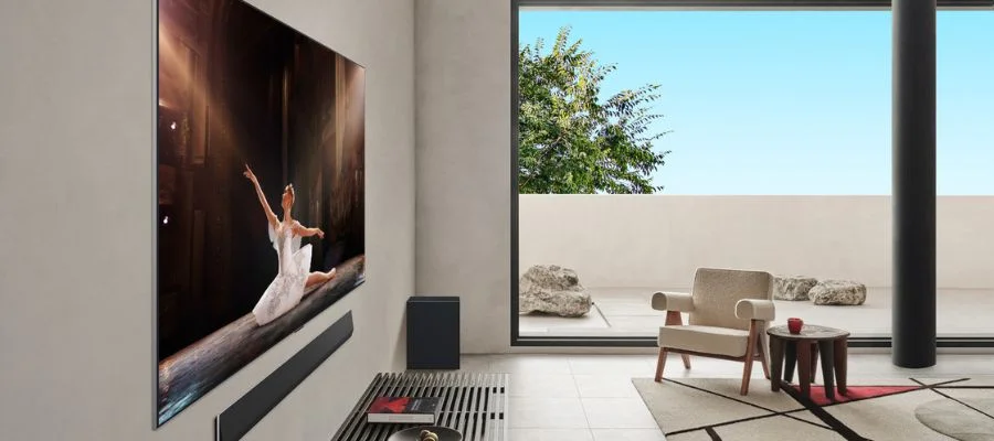 A direct angled shot of the LG G5. While viewers get an angled look at the TV, they see no glare and get a great view of what's on the television: a ballet. The room is white and daylight comes in through the large windows.
