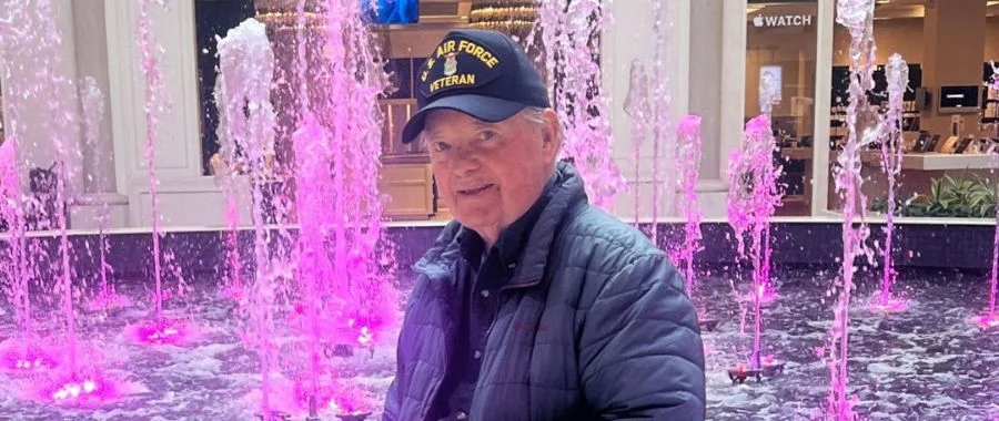 Customer Charles with his military hat in front of the fountain in Abt's atrium