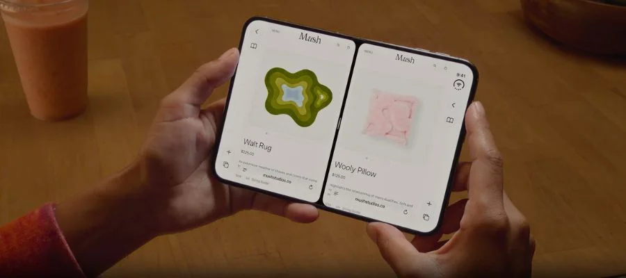 Person using an iPhone Duo's large open display to look at two windows side-by-side.