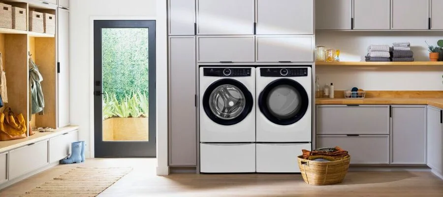 A modern laundry room with white appliances.