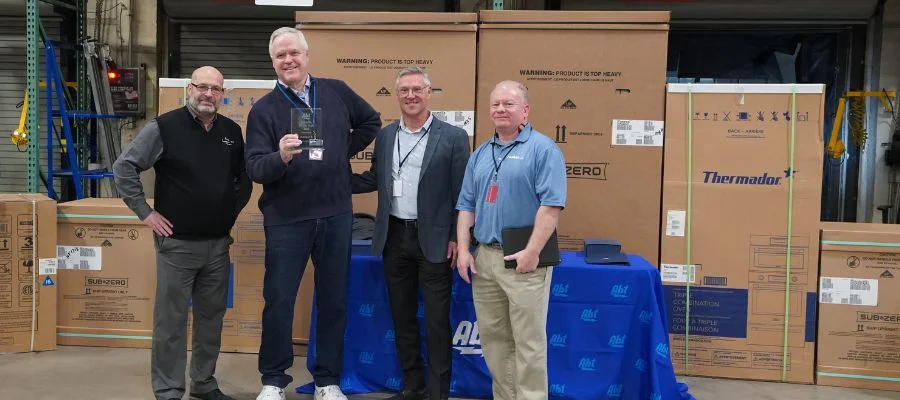 The team from Hangar A accepting a Carrier of the Year award beside Abt's Gary Quinton