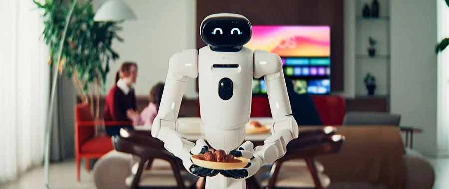 CLOiD LG robot in front of a living room holding a plated croissant with a happy face display