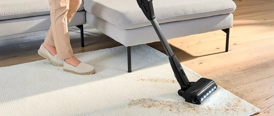 The Bosch Unlimited 10 cleaning a spill on a white carpet.