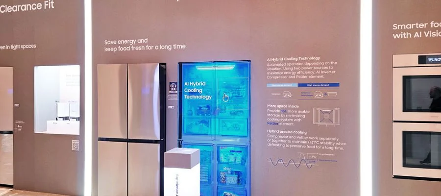 A four-door samsung refrigerator beside a display of their hybrid cooling technology and the text 'save energy and keep food fresh for a long time'.