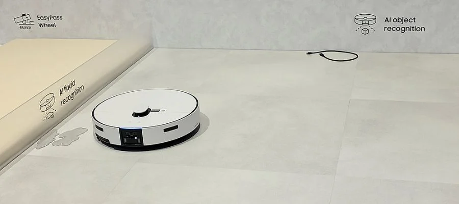 The Bespoke AI Jet Bot Steam Ultra in a display at CES 2026. Text nearby says 'ai liquid recognition' and 'ai object recognition'