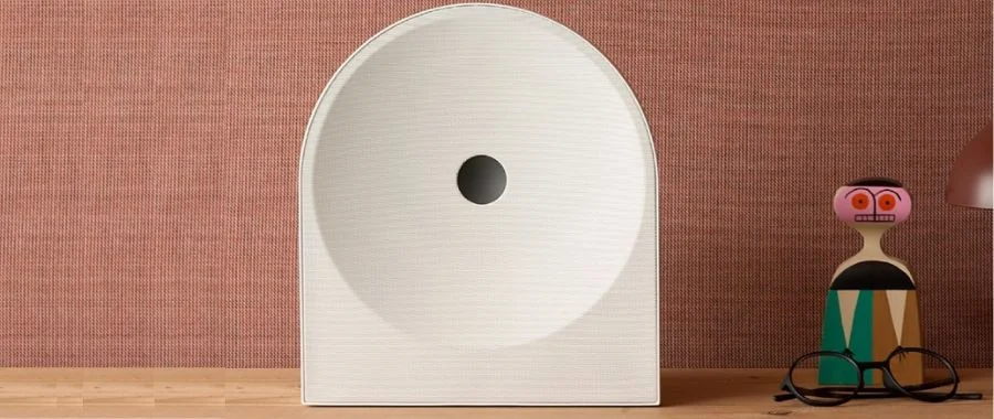 The Samsung Music Studio 7 speaker in white sitting on a wooden shelf.