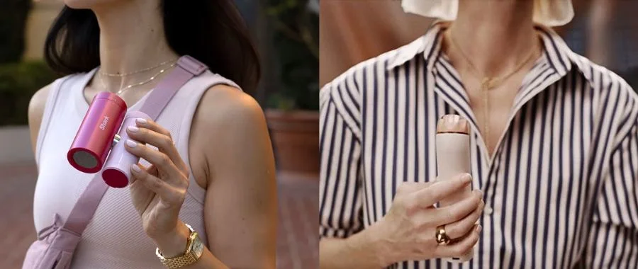 Side by side images of a woman holding a pink Shark ChillPill fan and a woman in a striped shirt holding the Dyson HushJet Mini Cool.