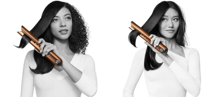 black and white photo of two women, one with curly hair and one with straight hair, using Dyson Corrale