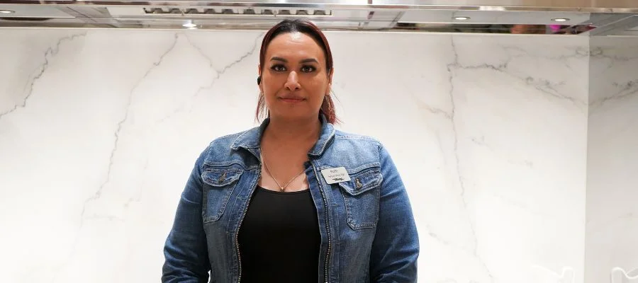 Ruby Escamilla in the Abt Inspiration Studio in front of a veined white backsplash