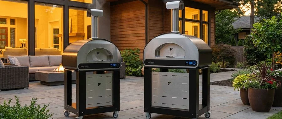 Two Fontana Volta pizza ovens on a home's back patio on carts.