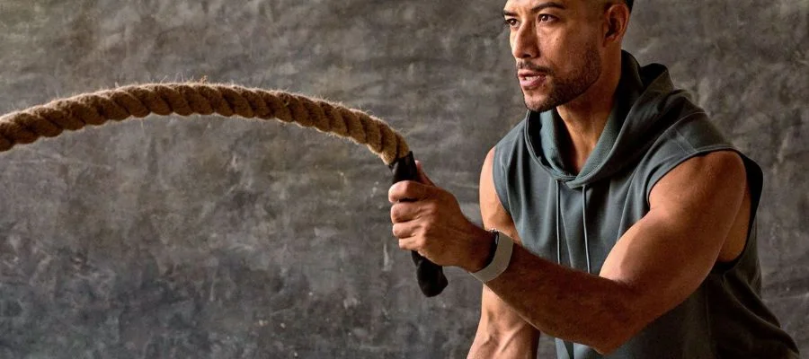 A man working out while wearing the Garmin Cirqa in French Gray.