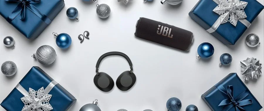 Flat lay of headphones and black portable speaker with blue ornaments.