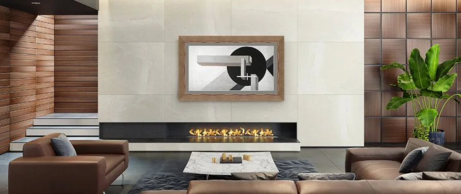 Samsung Frame TV with a light wood bezel mounted above a fireplace in a modern living room.