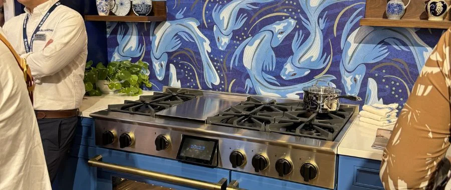 An image of BlueStar's West Vignette at KBIS 2026, focusing on their 48-inch range and the koi mural backsplash behind the range