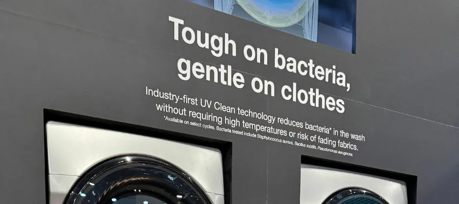Text above the washer-dryer stackable reading 'Tough on bacteria, gentle on clothes' and going on to describe how the technology is an industry first and reduces bacteria in the wash without requiring high temperatures