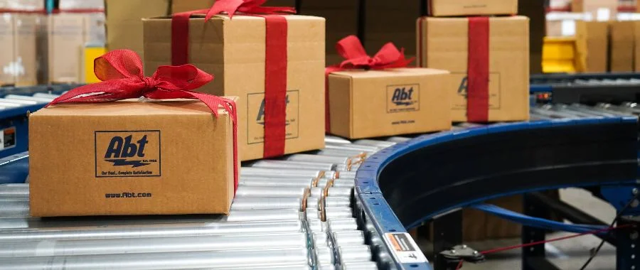 Abt packages wrapped with red ribbons getting ready to be shipped out.
