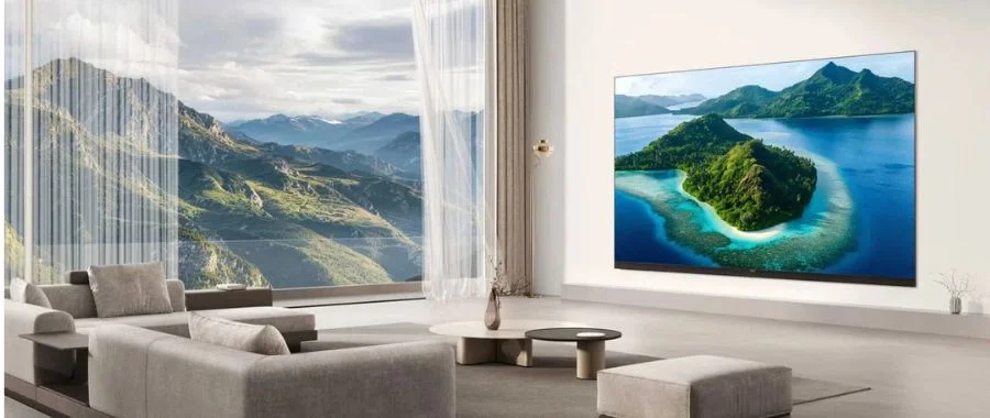 The TCL X11L TV mounted to the wall in a modern living room.