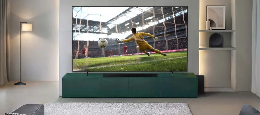 Samsung M80H TV with a soccer game on sitting on a TV stand.