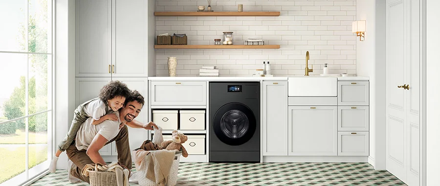 man and child doing laundry in front of Samsung all-in-one washer dryer