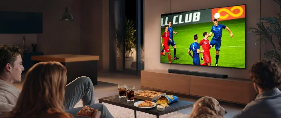 A trio watching a soccer game on the Samsung QN80H.