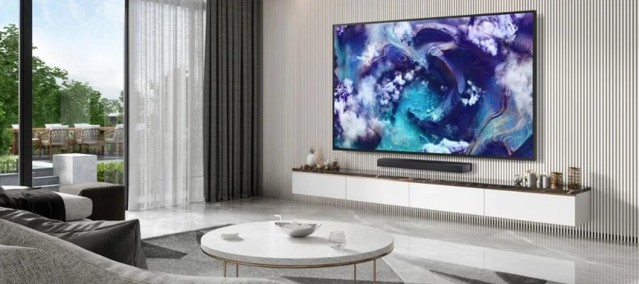 The Samsung QN900F TV mounted to the wall of a modern living room.