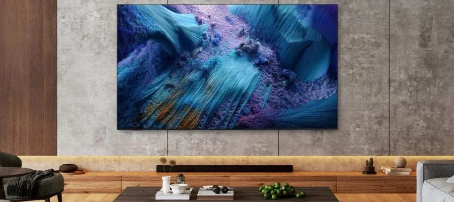 The Samsung QN990F TV installed in a modern living room.