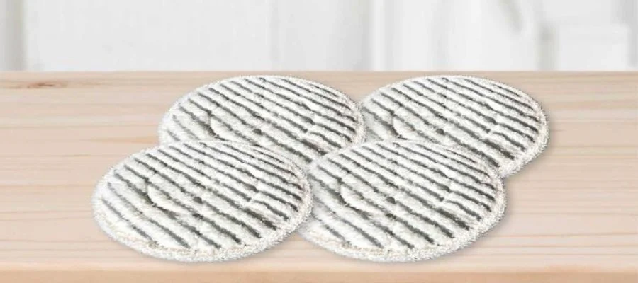 Four Shark Dirt Grip scrub pads on a wood floor.