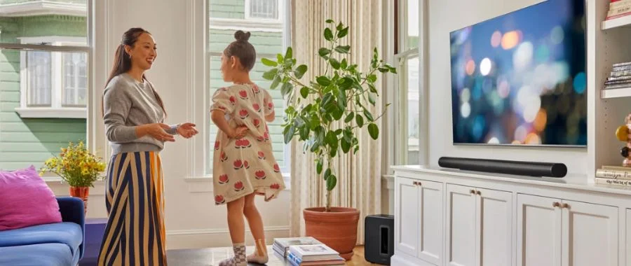 The black Sonos Arc Ultra soundbar mounted beneath a TV in a living room.