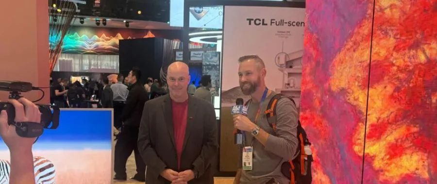Abt's video team speaking with CES 2025 representatives at the TCL booth
