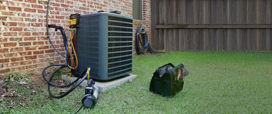 An outdoor air conditioner being worked on.