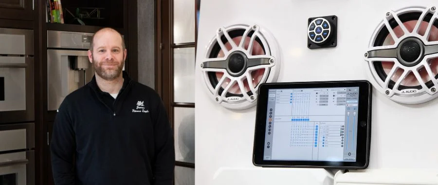Abt mobile audio expert James next to a modern boat sound system.