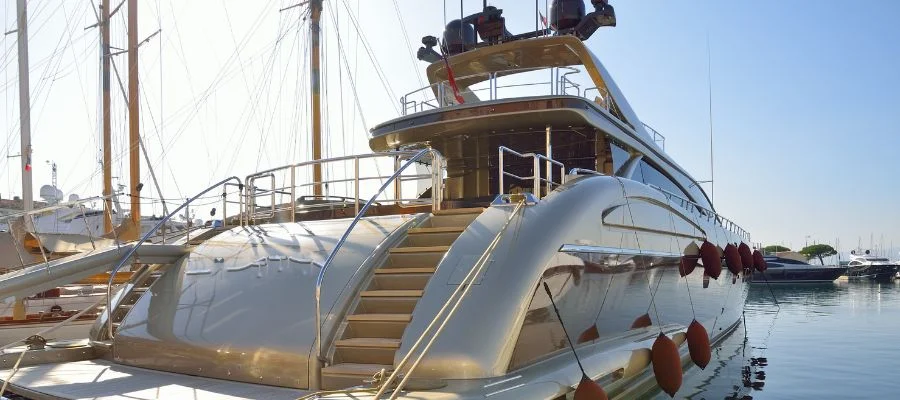 A rear shot of a docked modern yacht.