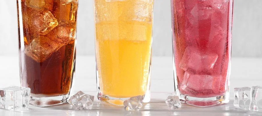 Cubed ice shown in three different beverages.