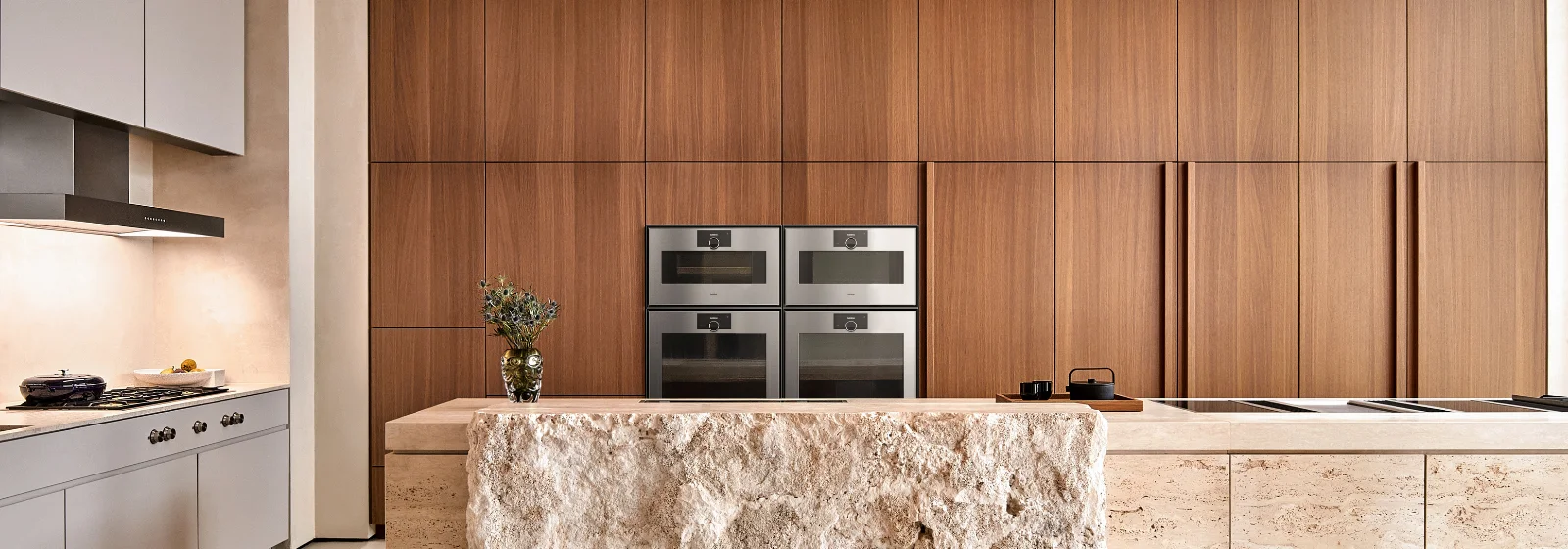 Stylish kitchen featuring Gaggenau appliances, with expansive windows revealing a beautiful lake view