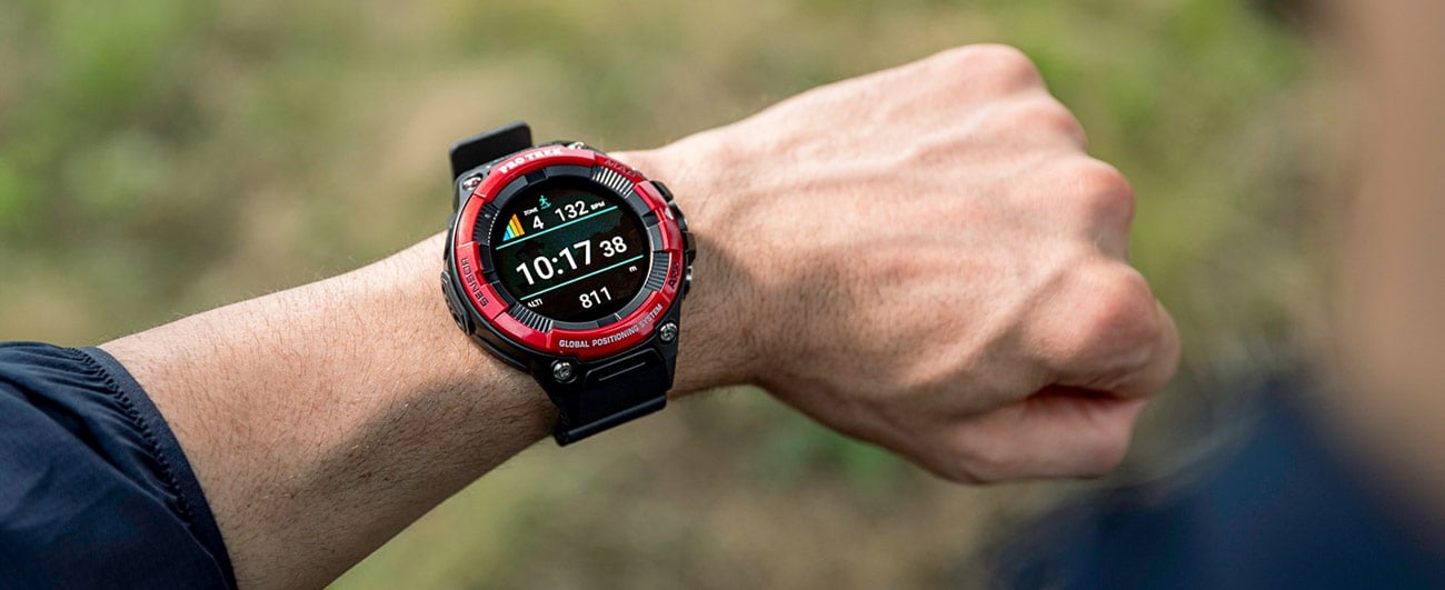 Person wearing a red and black digital watch