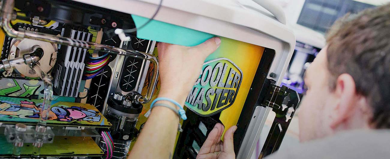 Person installing cooler master logo inside a computer