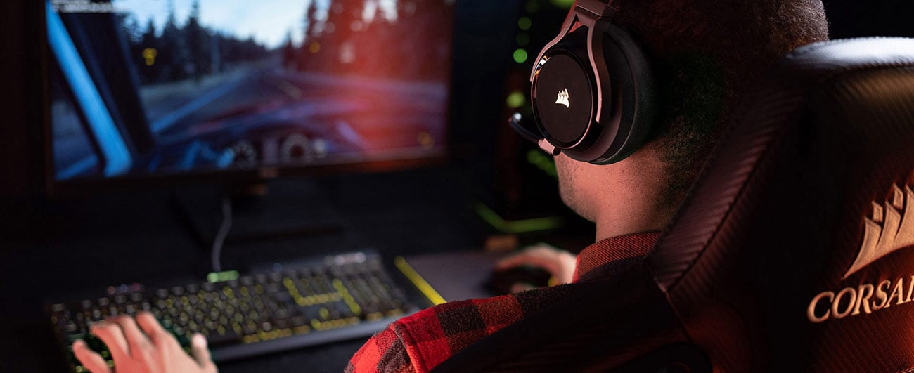 Person gaming on a computer with headphones