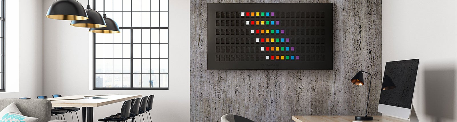 A large Vestaboard mounted on a wall