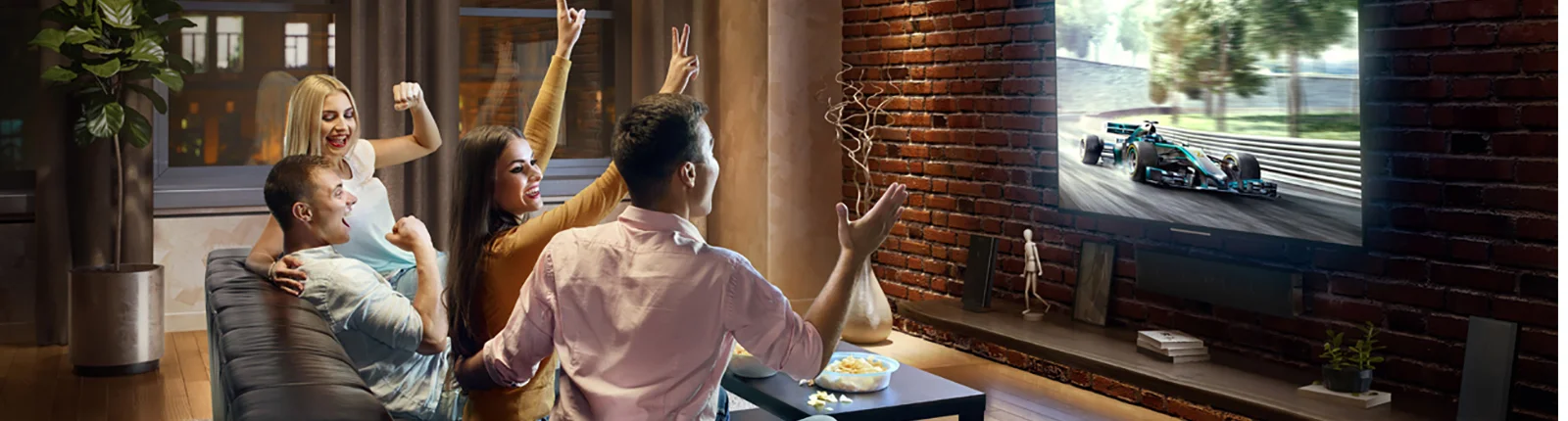 Group of people celebrating while watching TV