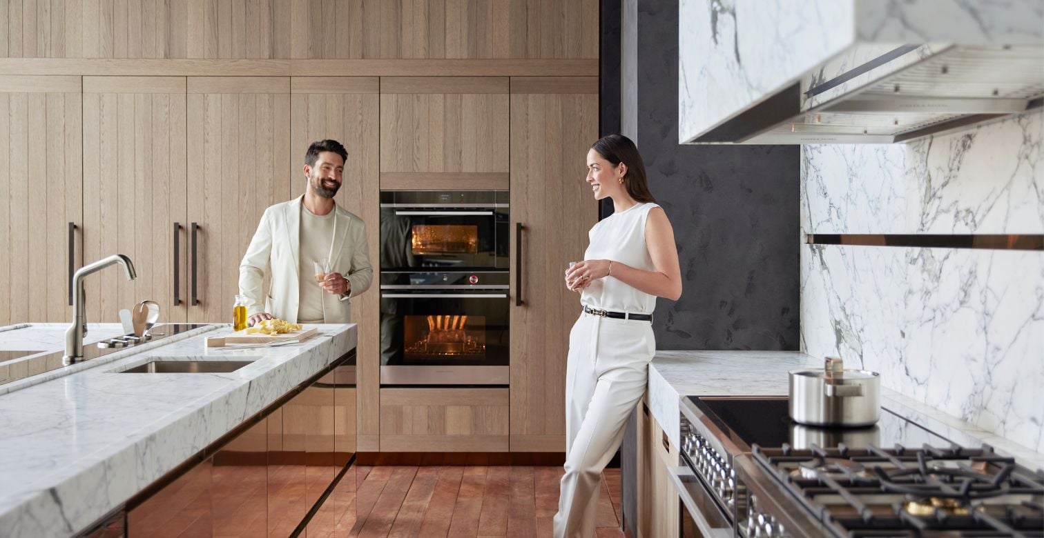 Stylish kitchen featuring Gaggenau appliances, with expansive windows revealing a beautiful lake view