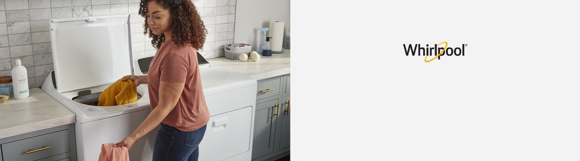 Woman putting load of laundry into washer