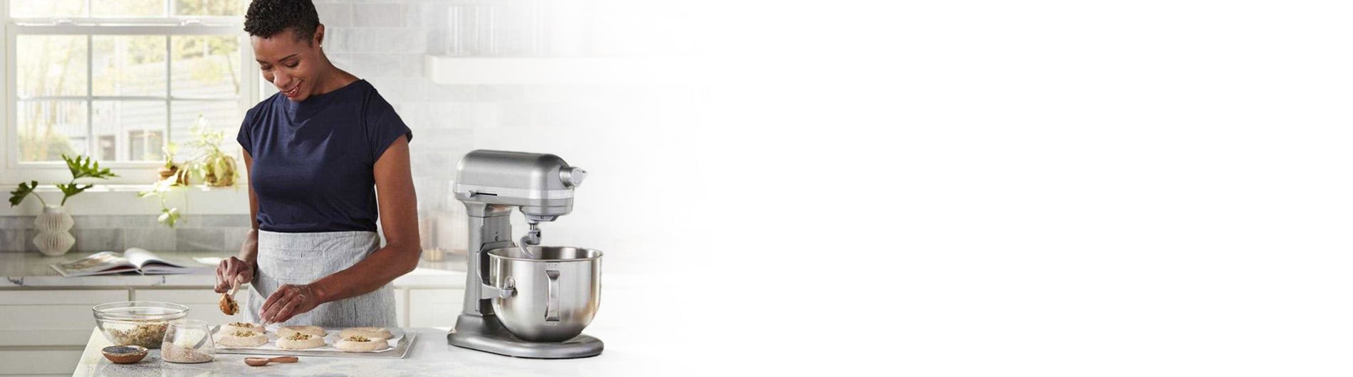 Woman using stand mixer and baking in kitchen