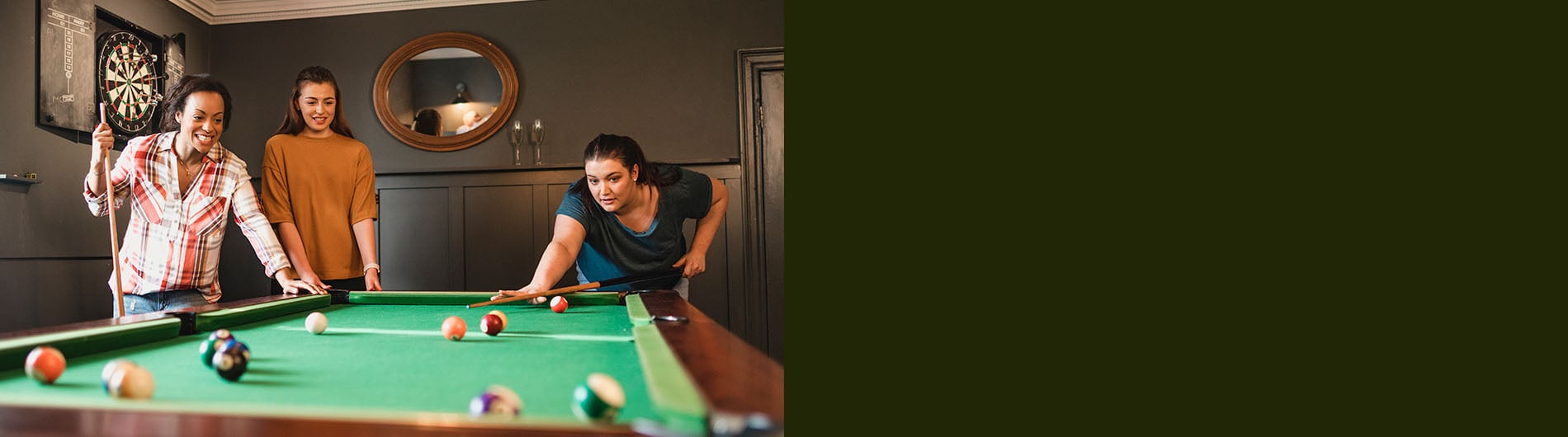 Friends playing pool in gameroom