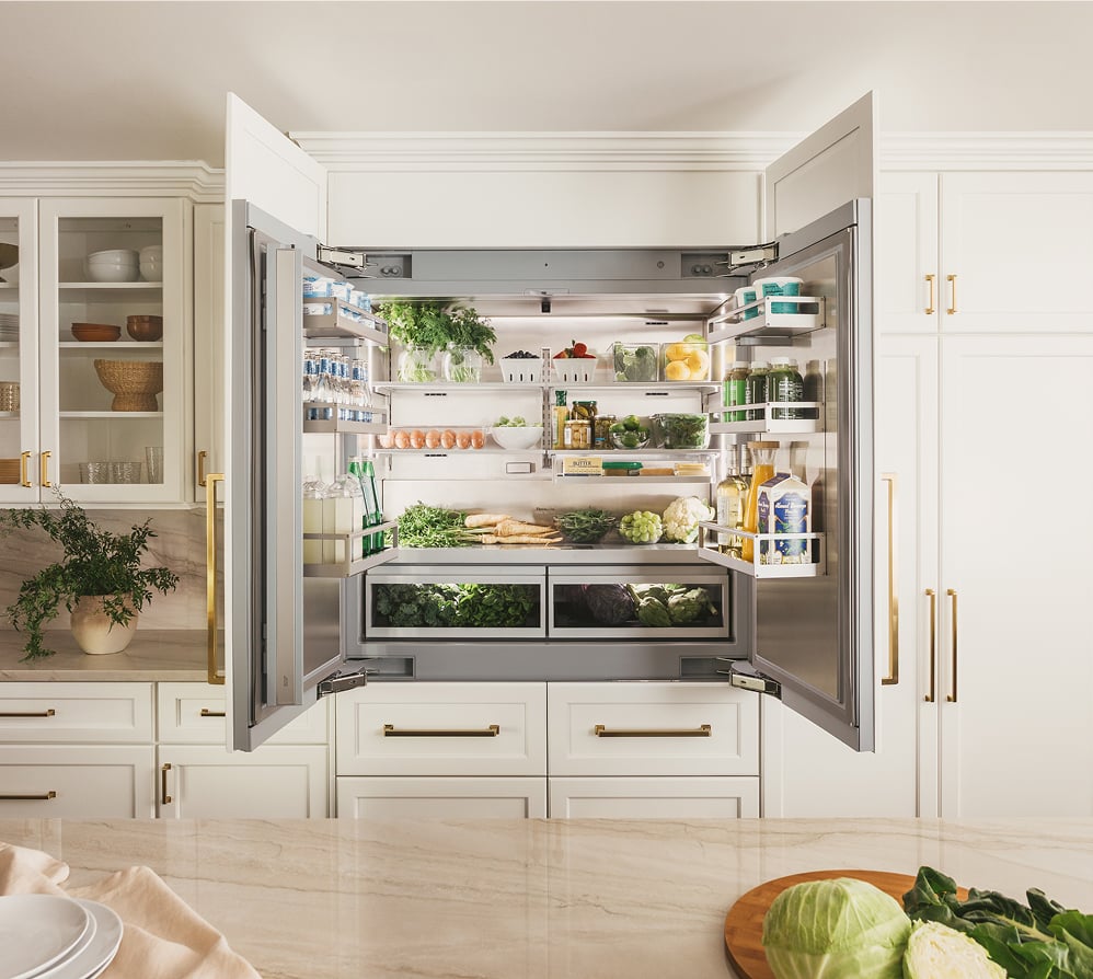 Thermador Freedom Collection Bottom Freezer Refrigerator with open French doors displaying fully stocked interior and bottom freezer drawers in modern kitchen