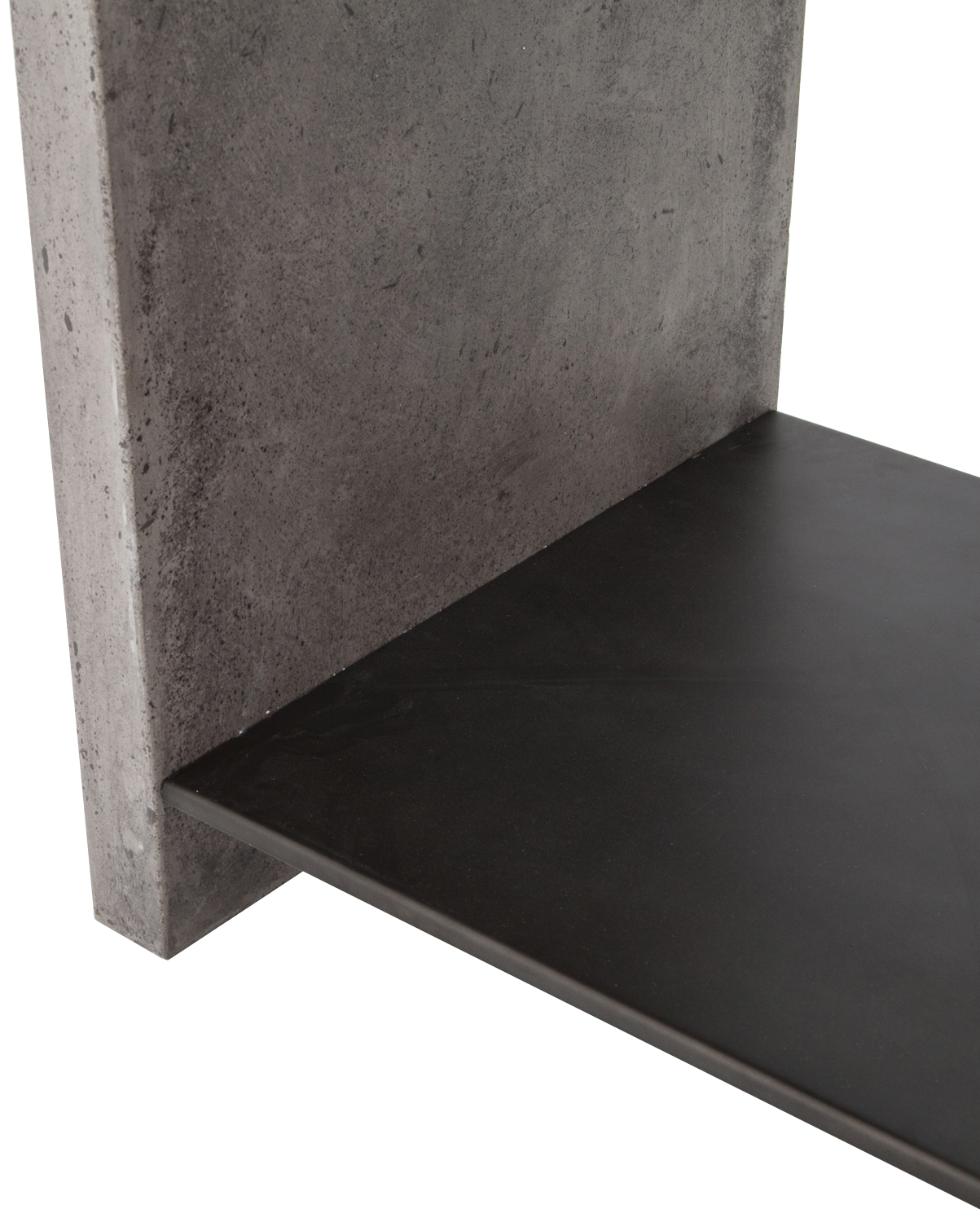 A close-up of the corner of a gray concrete side table