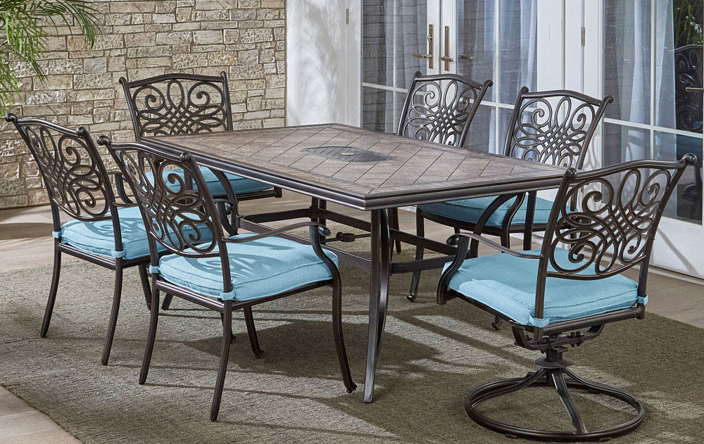 Close-up of turquoise fabric cushion on a wrought-iron patio chair.