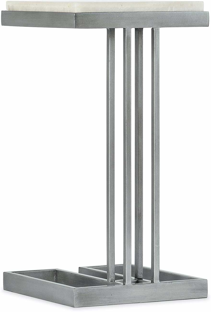 A close-up of a table base with four thin metal legs and a rectangular metal frame.